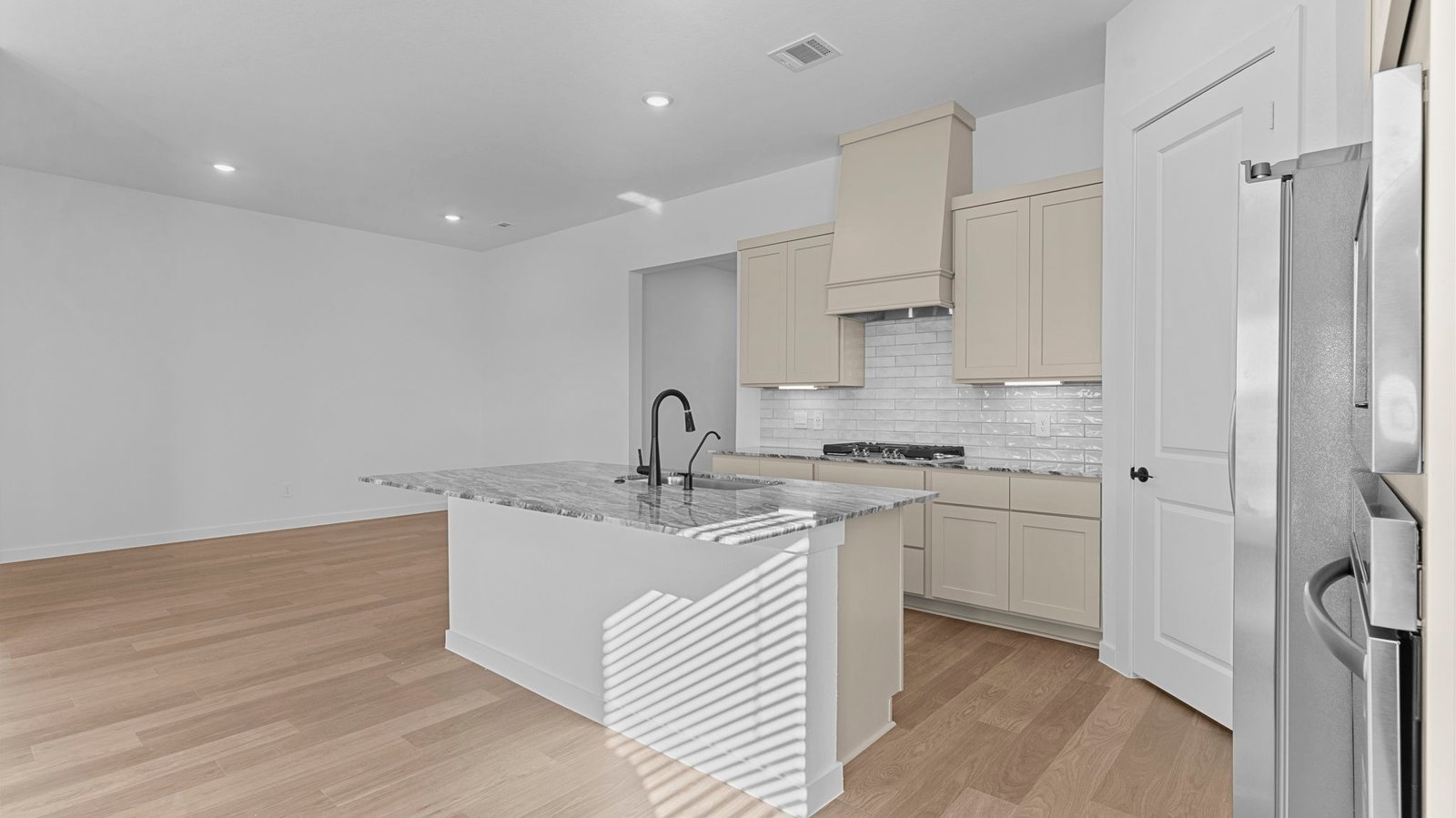 open concept kitchen with a large island and walk in pantry
