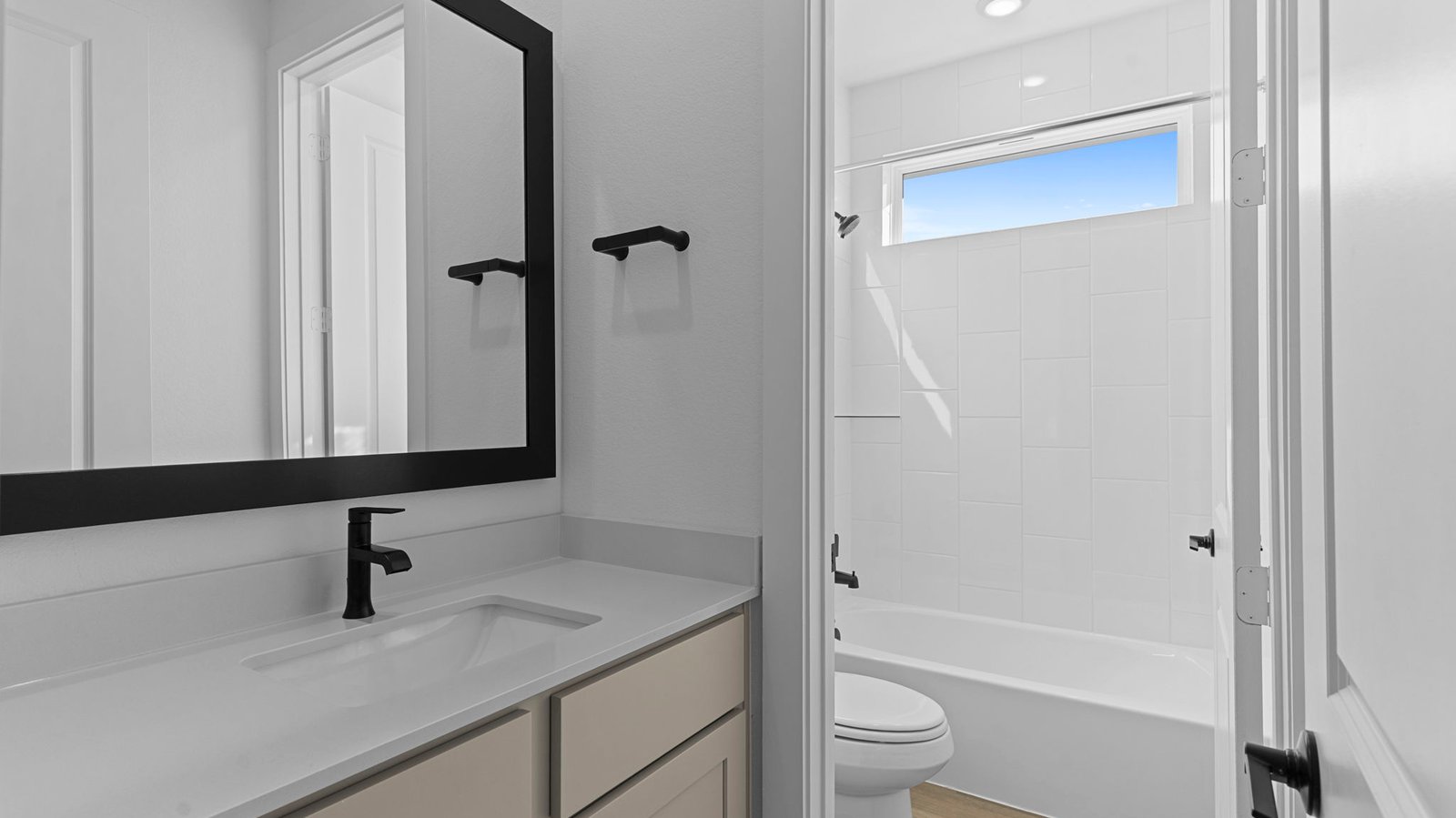 A well-designed bathroom equipped with quartz countertops, a standing tub, and a single vanity.