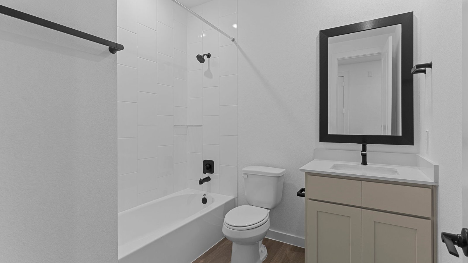 A well-designed bathroom equipped with quartz countertops, a standing tub, and a double vanity.