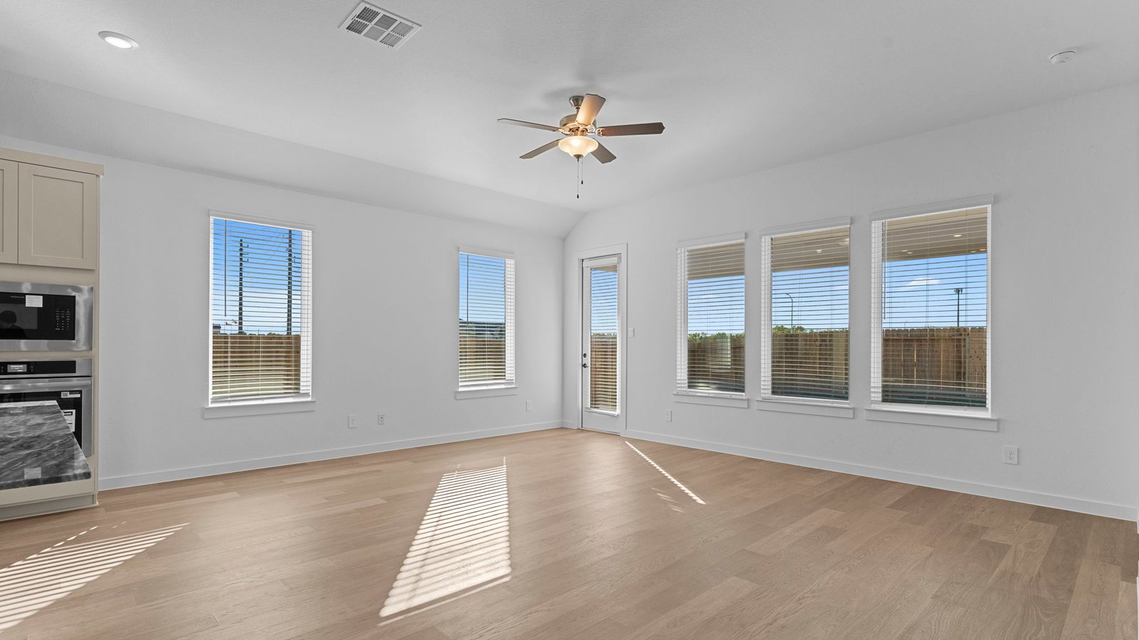 A well-organized living room that includes a kitchen and dining area, creating a warm and welcoming environment for gatherings.