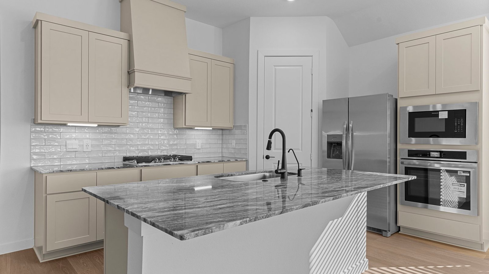 Kitchen adorned with stained wood cabinets seamlessly integrated into an open dining area layout.