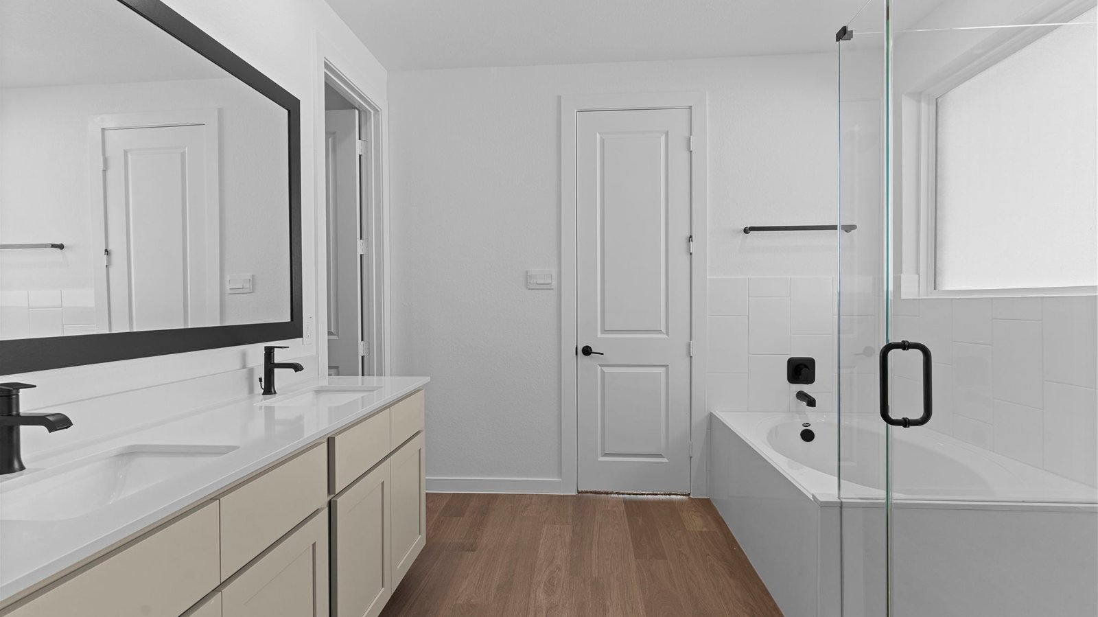 Primary bathroom with a glass-enclosed standing shower and separate soaking tub.