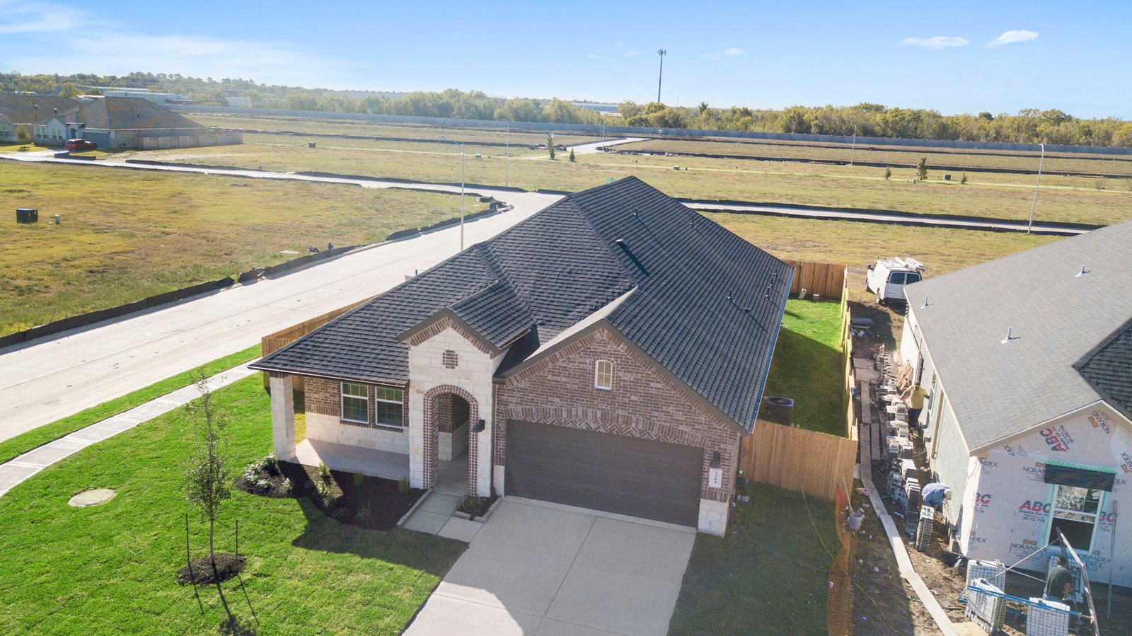 An aerial view of the one story home with stone and brick exterior