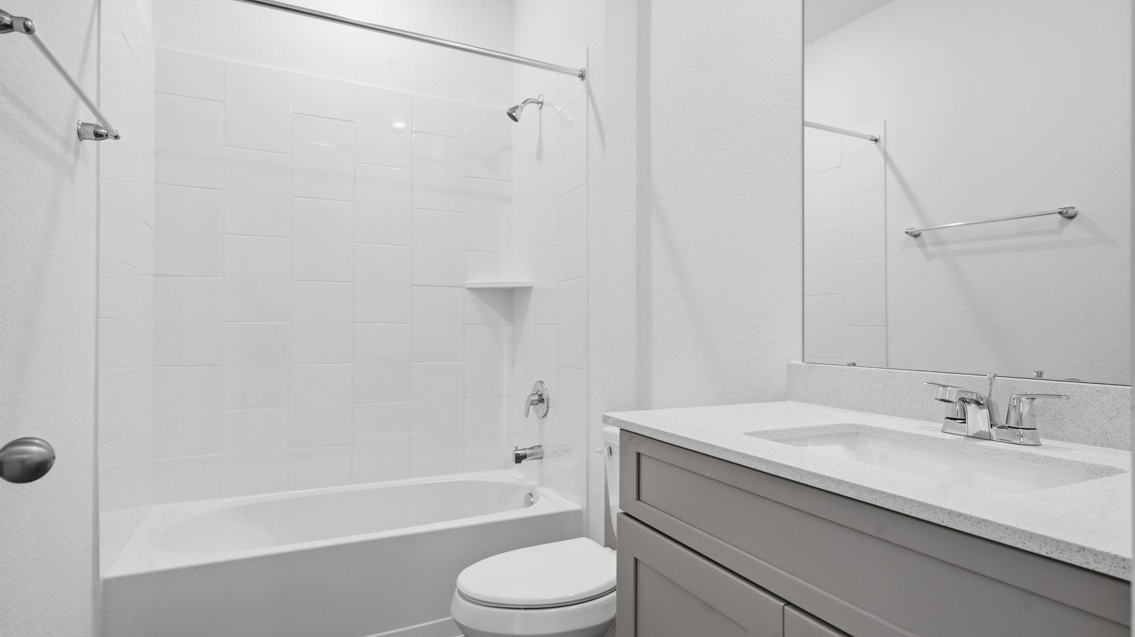 A well-designed bathroom equipped with quartz countertops, a standing tub, and a single vanity.