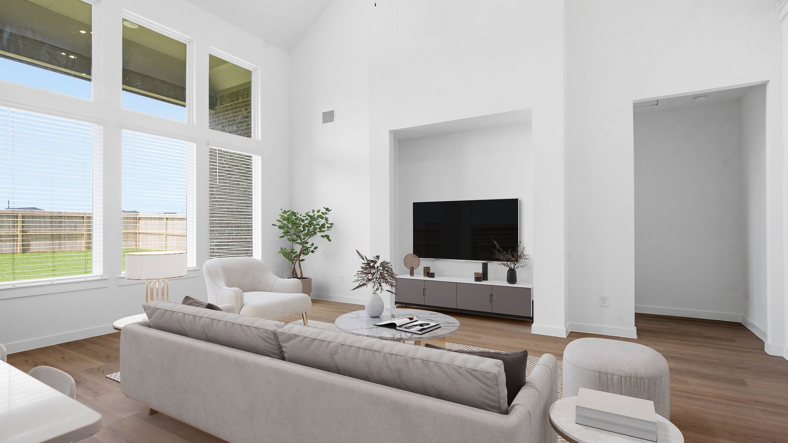 A well-organized living room that includes a kitchen and dining area, creating a warm and welcoming environment for gatherings.