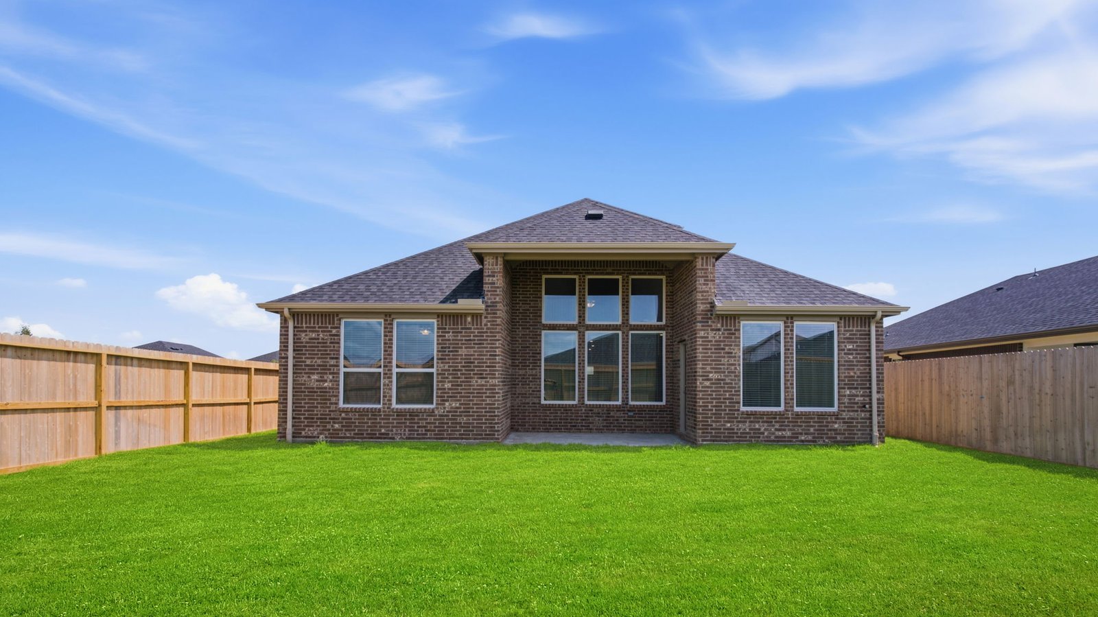 Large fenced-in backyard with a covered patio, perfect for outdoor entertaining.