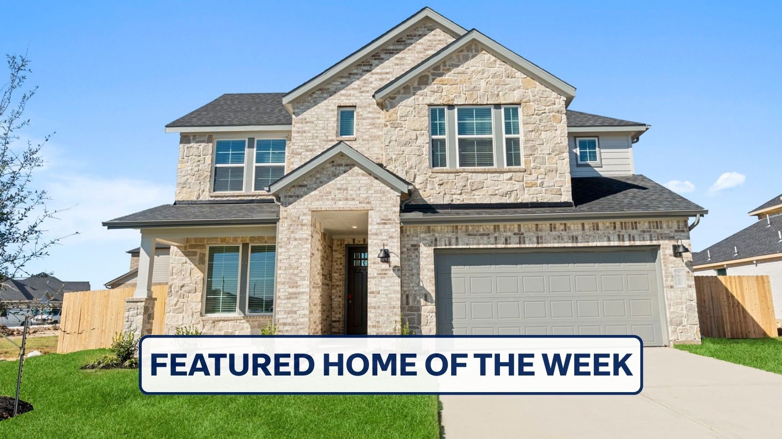 two story brick home with a two car garage