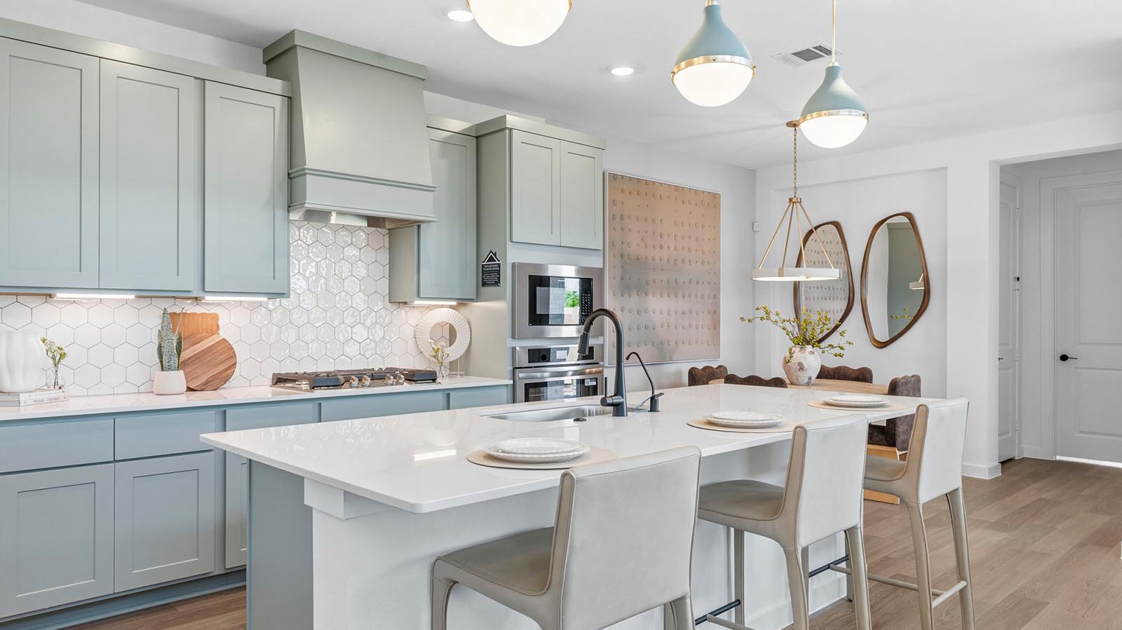 Bright and spacious kitchen with granite countertops, stainless steel appliances, and an island with bar seating.