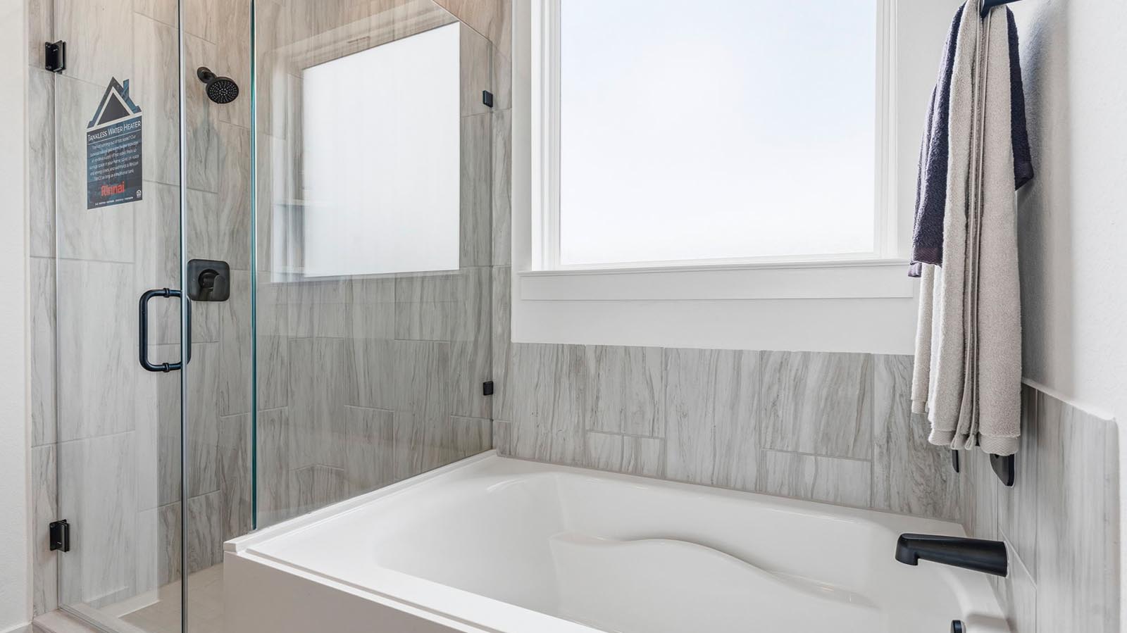 primary bathroom tun and shower