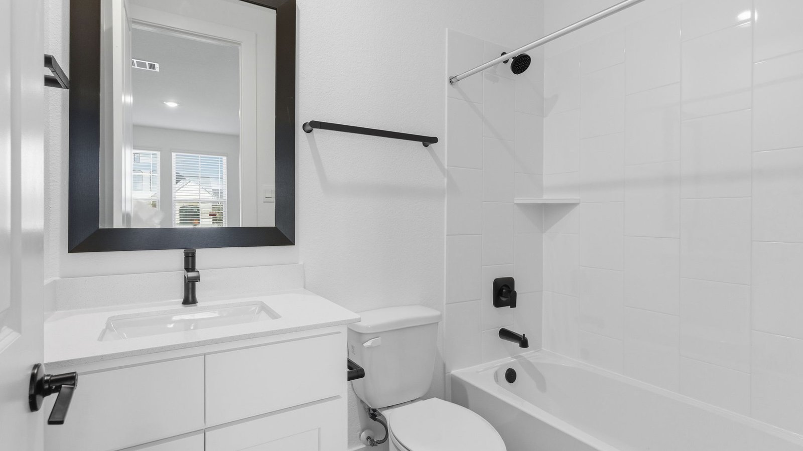 A well-designed bathroom equipped with quartz countertops, a standing tub, and a single vanity.