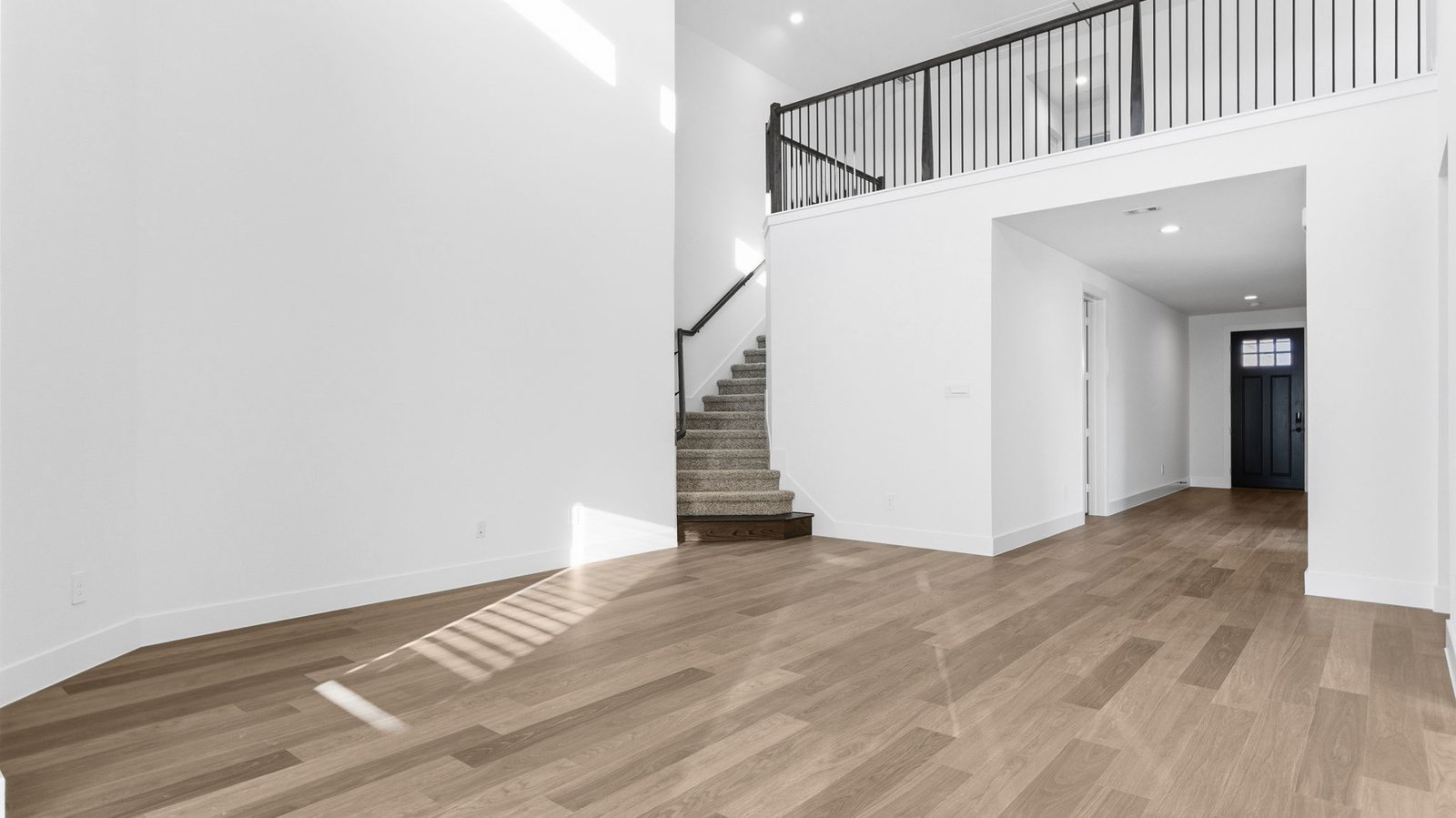 A well-organized living room that includes a kitchen and dining area, creating a warm and welcoming environment for gatherings.