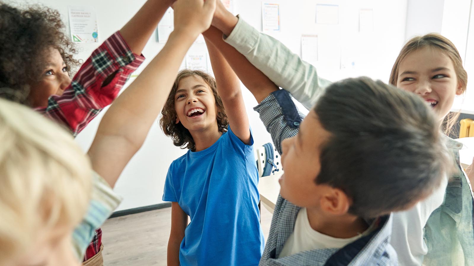 Children high fiving at school