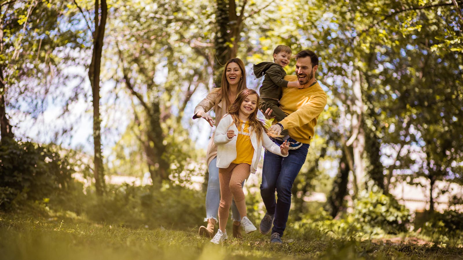 family playing in a grassy field