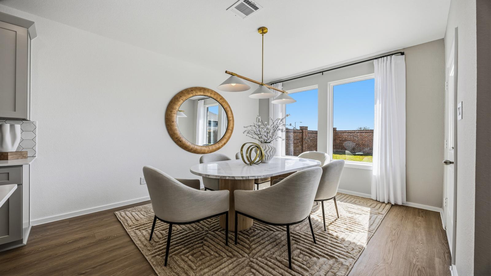 An open concept breakfast room with a large window.
