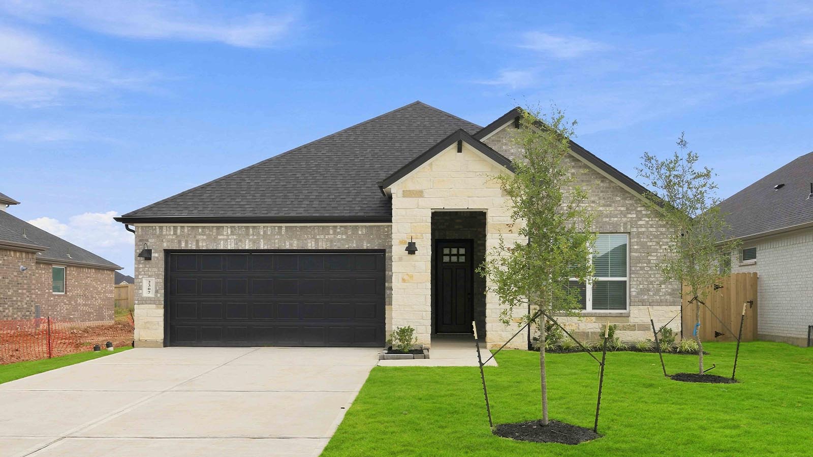 Newly built single story home with traditional architecture, a double garage, and landscaped front yard.