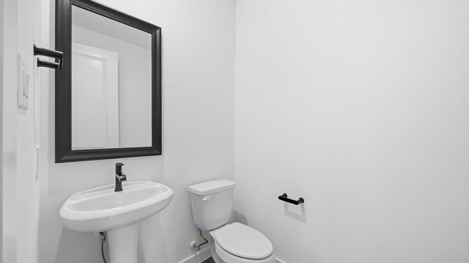 A decorated half bathroom downstairs for guests