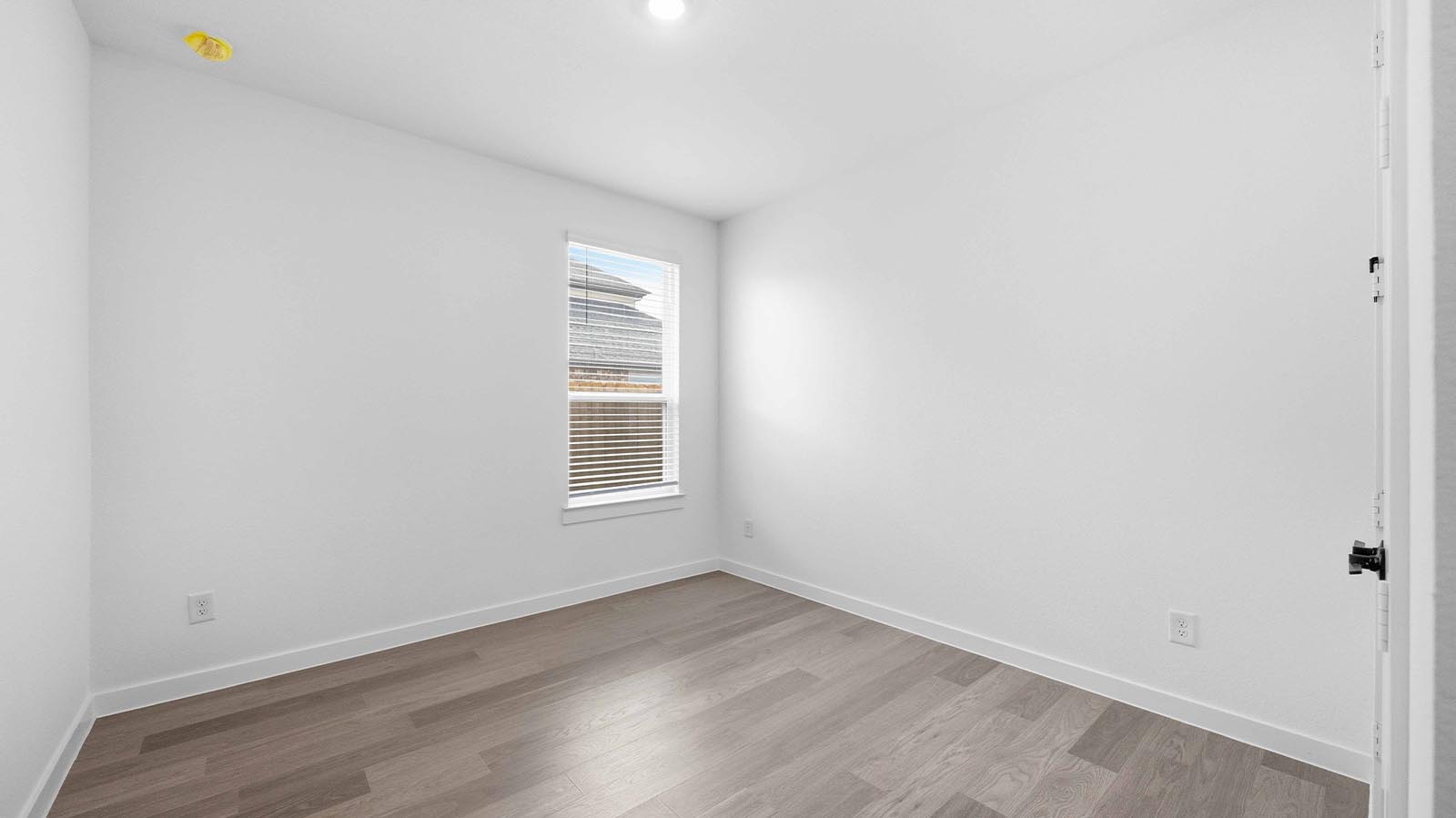 Comfortable guest bedroom featuring neutral-toned walls, carpeted flooring, and a separate closet.
