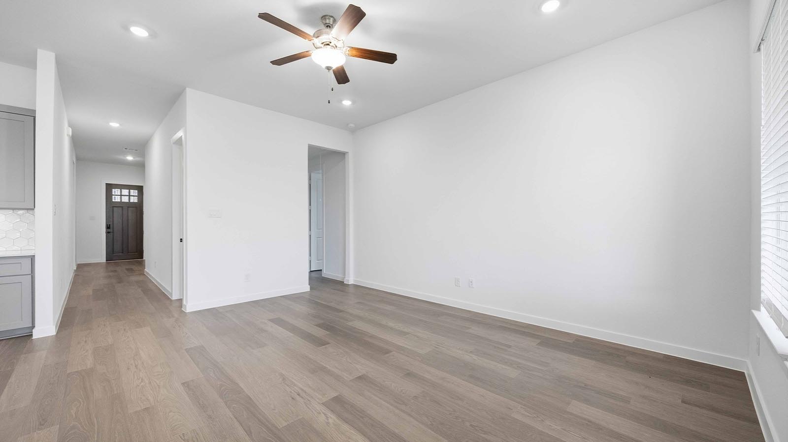 A well-organized living room that includes a kitchen and dining area, creating a warm and welcoming environment for gatherings.