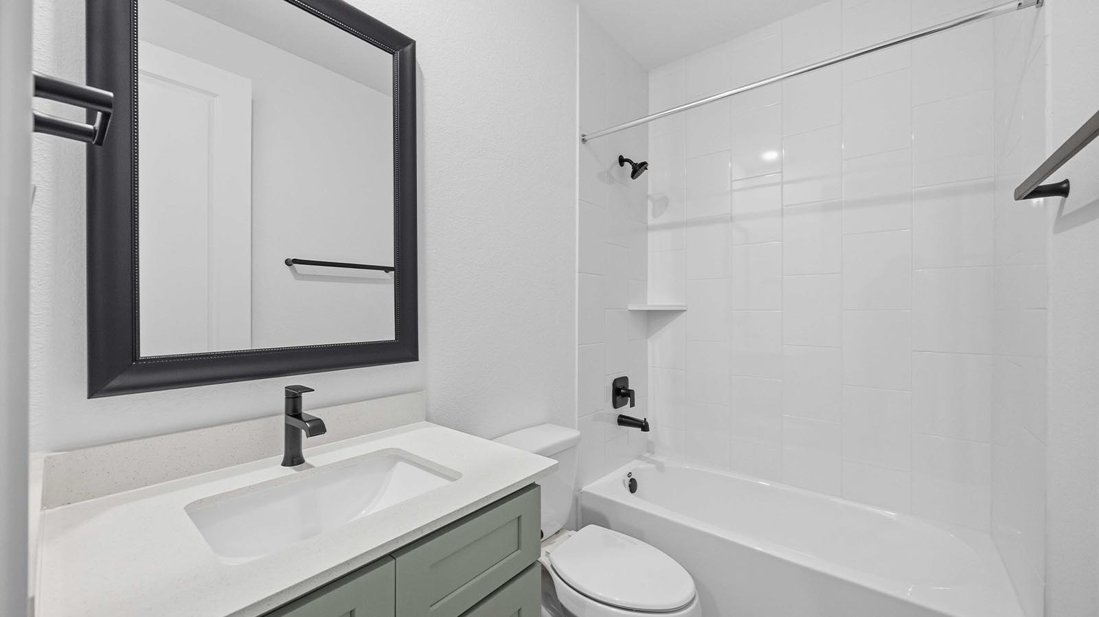 A well-designed bathroom equipped with quartz countertops, a standing tub, and a single vanity.