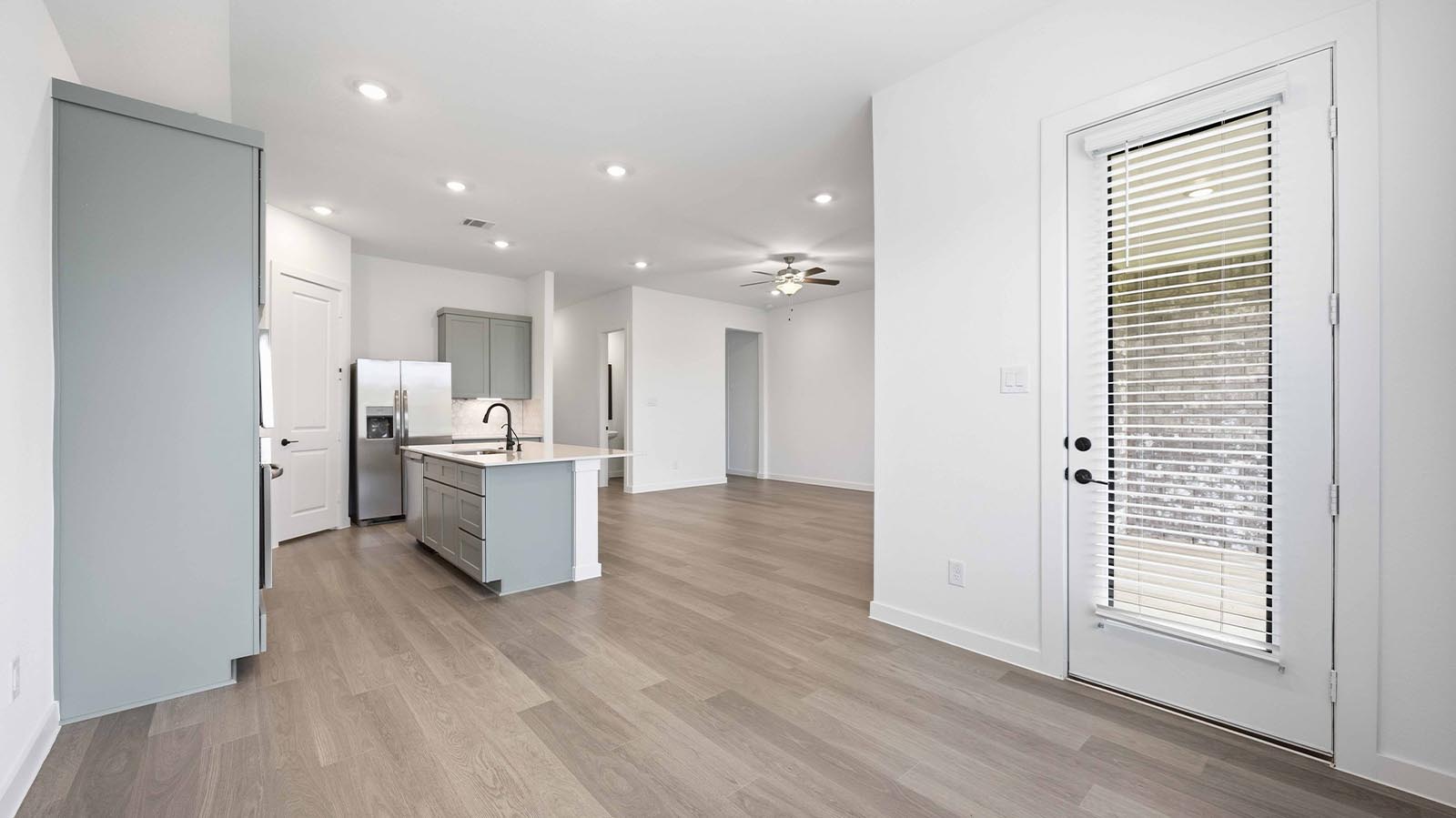 Spacious open concept dining area with vinyl wood flooring and access to the living and kitchen areas
