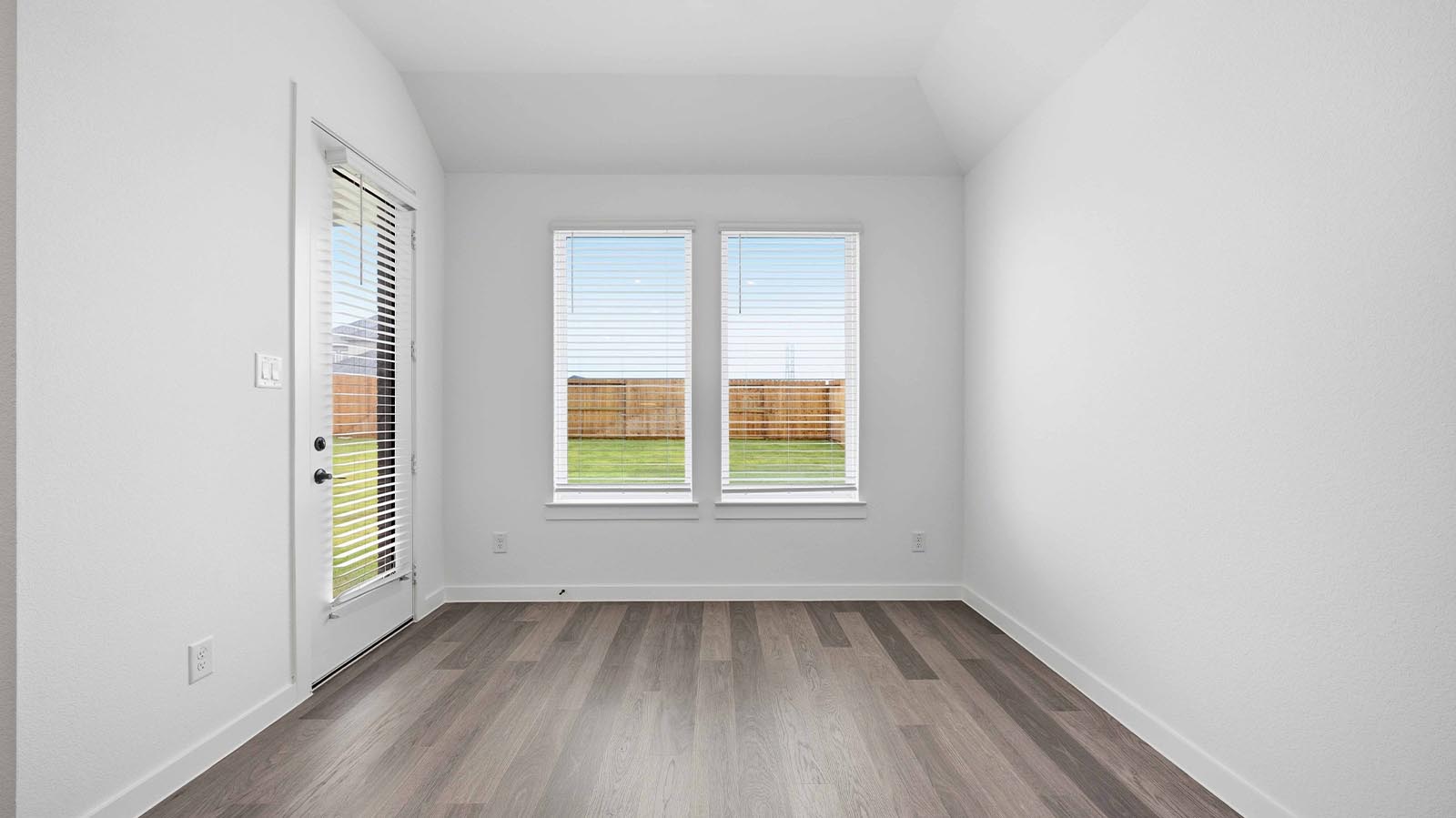 Spacious open concept dining area with vinyl wood flooring and access to the living and kitchen areas
