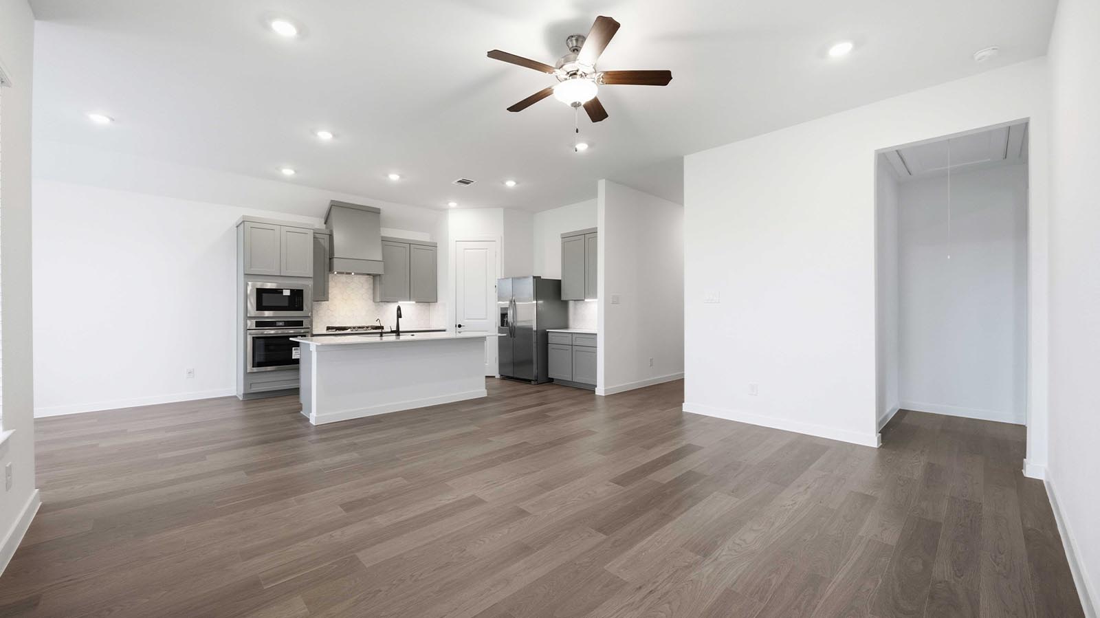 A well-organized living room that includes a kitchen and dining area, creating a warm and welcoming environment for gatherings.