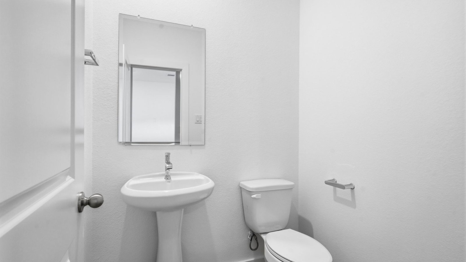 A decorated half bathroom downstairs for guests