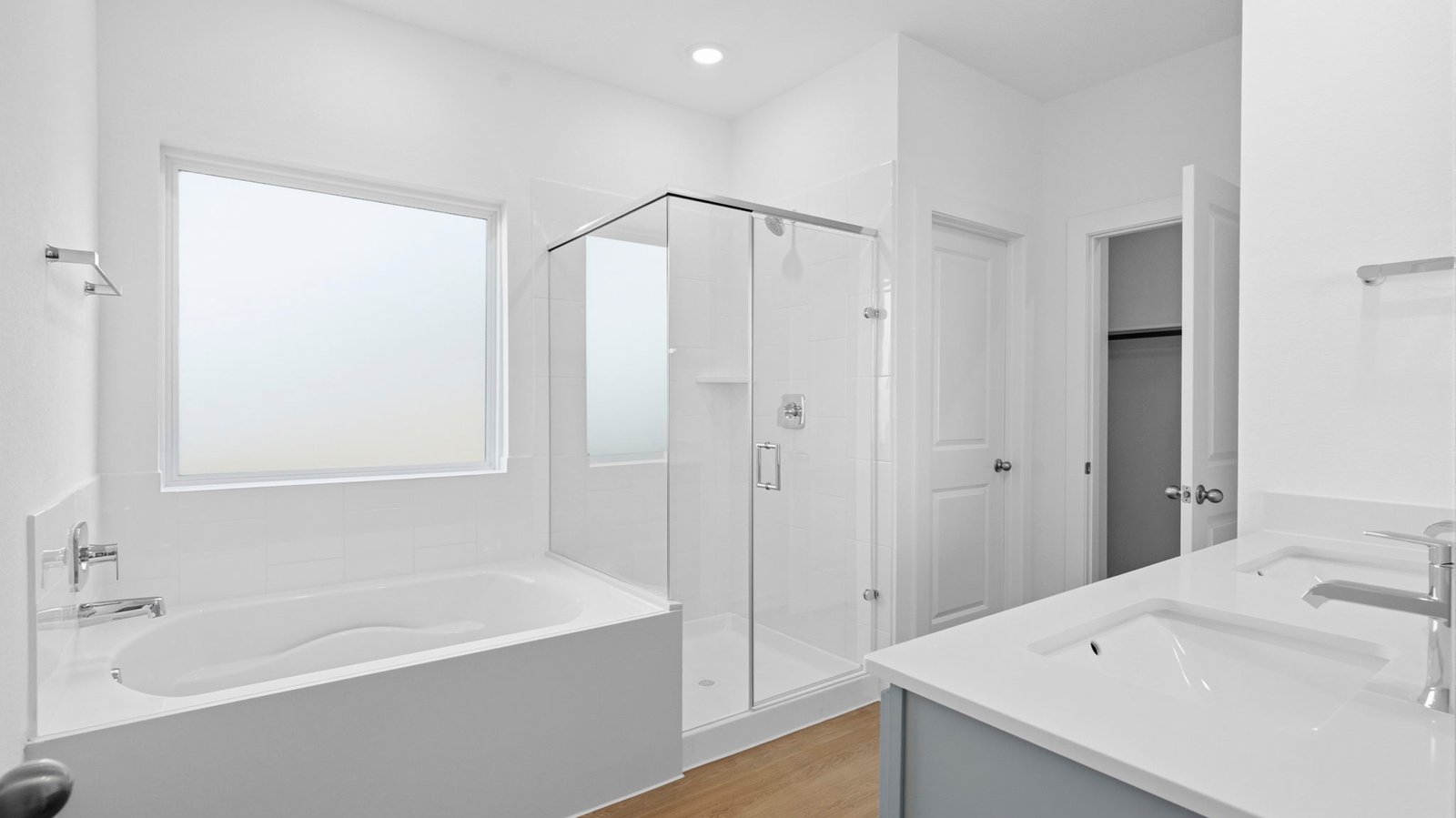 Primary bathroom with a glass-enclosed standing shower and separate soaking tub.