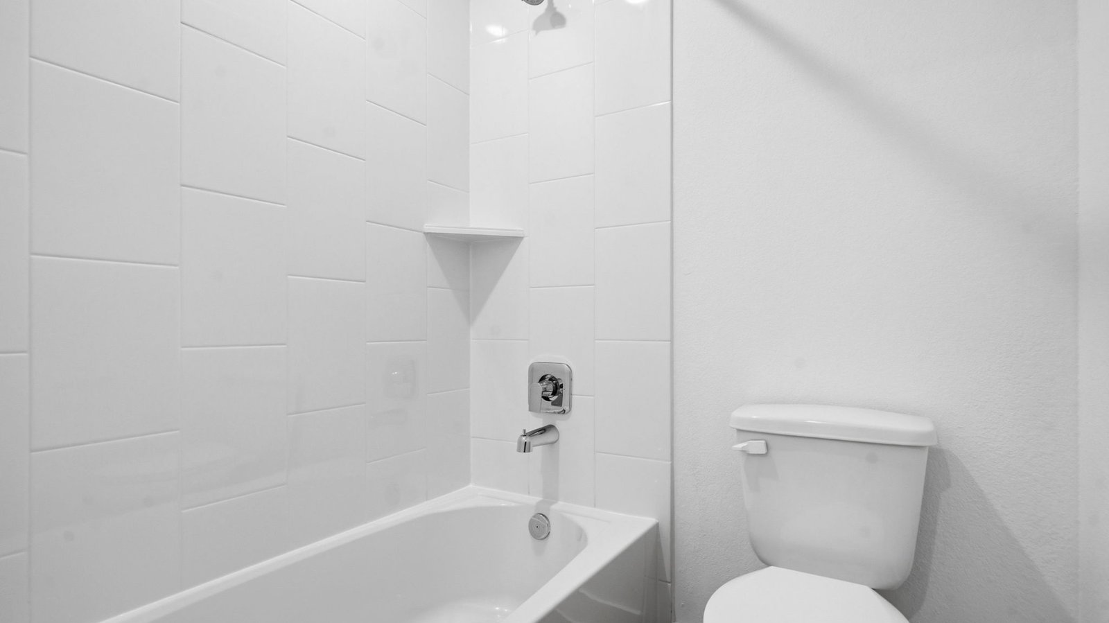 A well-designed bathroom equipped with granite countertops, a standing tub, and a single vanity.
