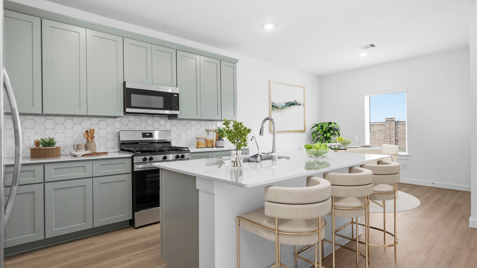 An open concept kitchen with an island with bar seating and access to the living and dining areas.