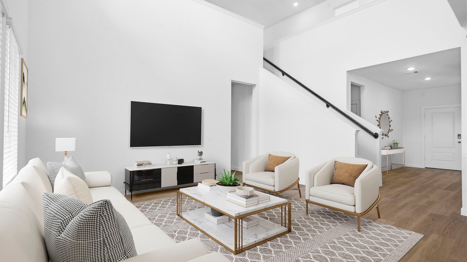 A luxurious living room featuring tall ceilings, large windows for natural lighting wood flooring and a view to the backyard.