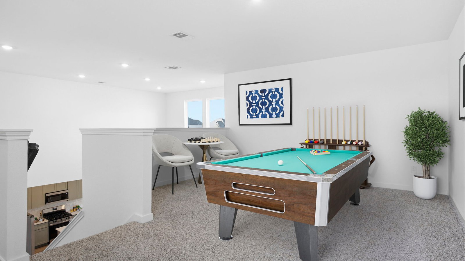 A spacious upstairs game room with plenty of natural light from windows overlooking side of the home