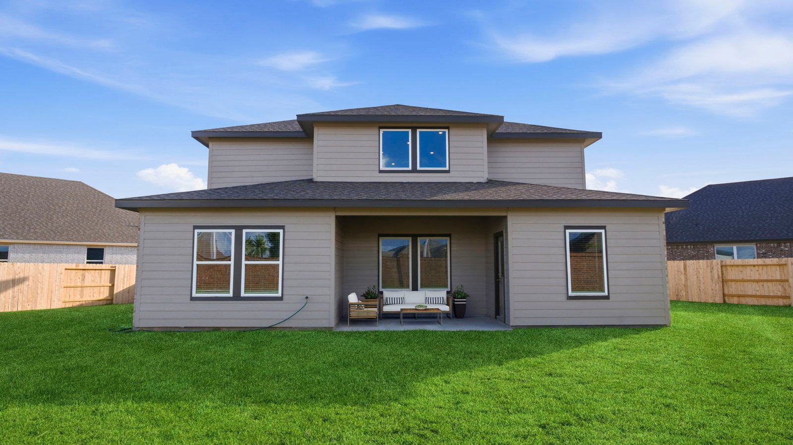 Large fenced-in backyard with a covered patio, perfect for outdoor entertaining.