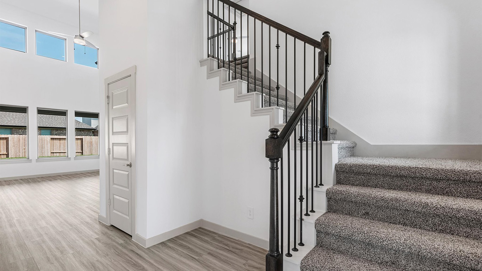 Entry hallway leading to living room and kitchen in the background.