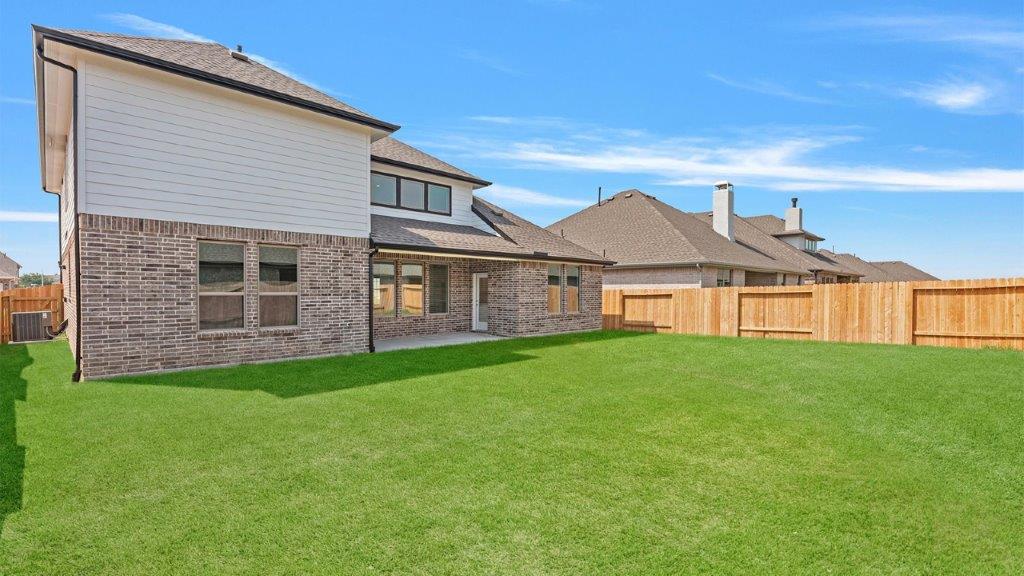 Large fenced-in backyard with a covered patio, perfect for outdoor entertaining.