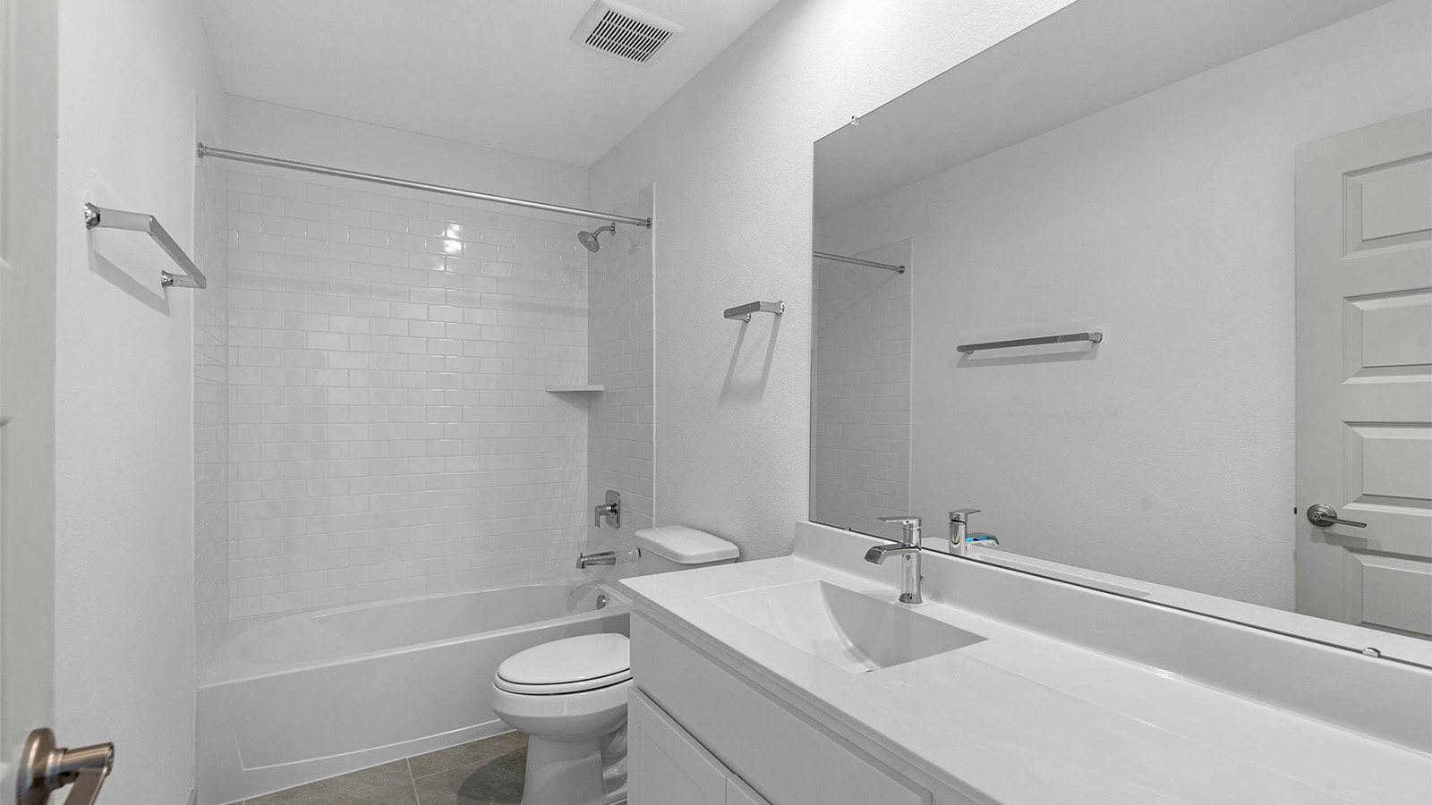 A well-designed bathroom equipped with quartz countertops, a standing tub, and a single vanity.