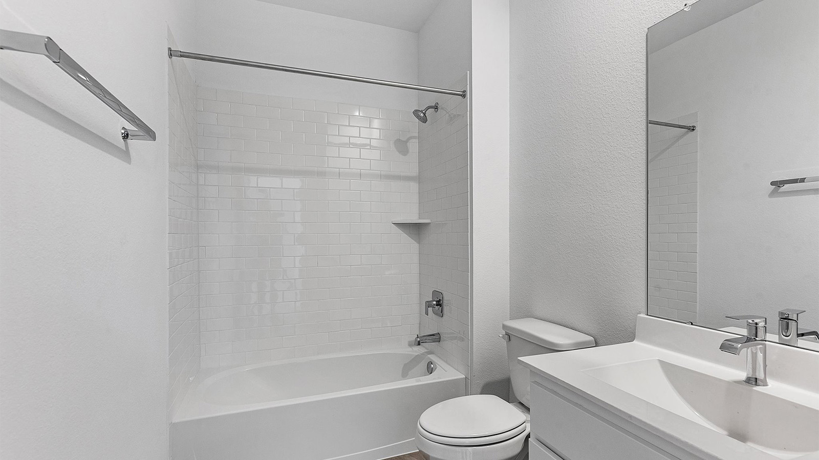 A well-designed bathroom equipped with quartz countertops, a standing tub, and a single vanity.