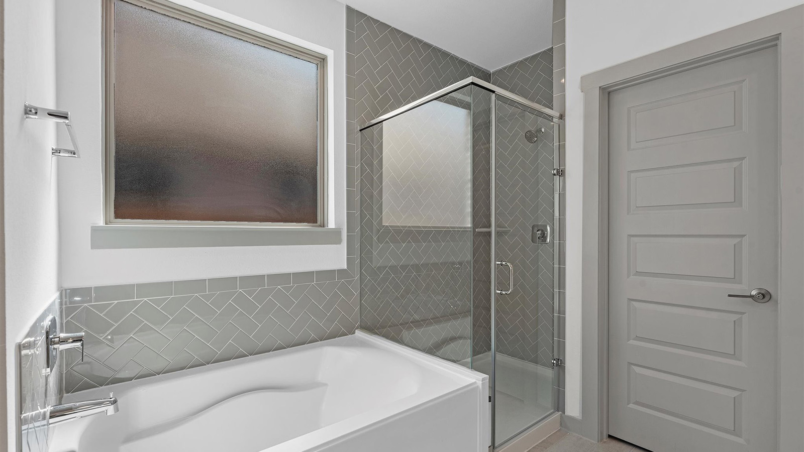 Primary bathroom with a glass-enclosed standing shower and separate soaking tub.