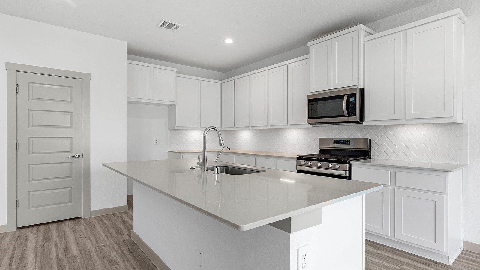 Kitchen adorned with painted cabinets seamlessly integrated into an open dining area layout.
