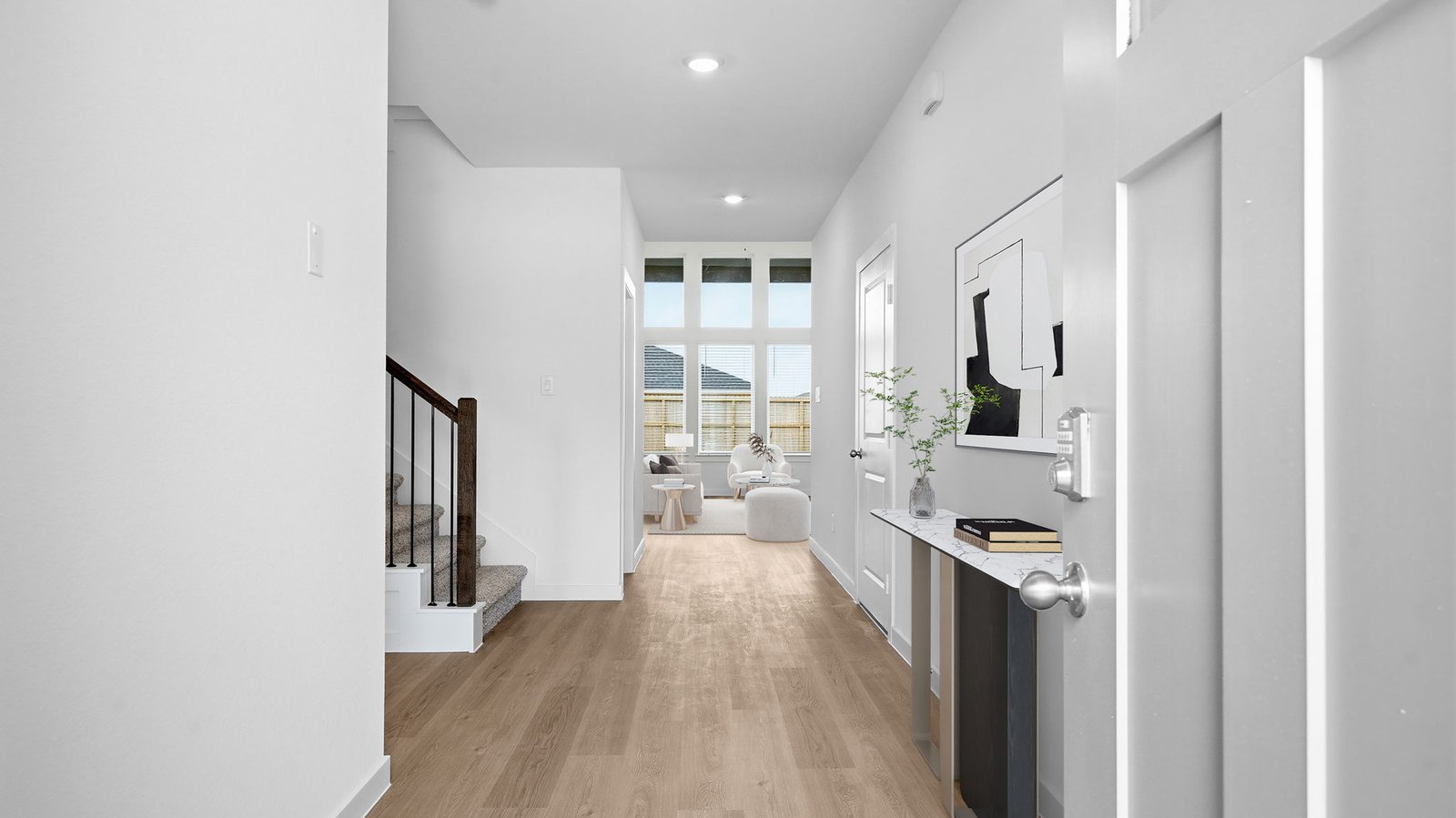 Entry hallway leading to living room and kitchen in the background.