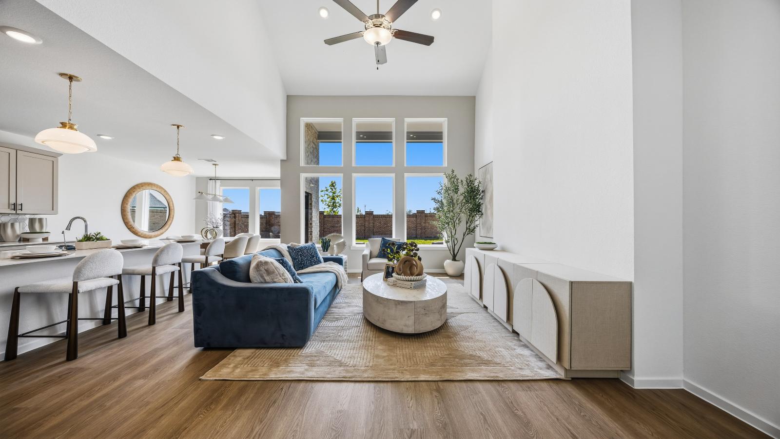 A well-organized living room that includes a kitchen and dining area, creating a warm and welcoming environment for gatherings.