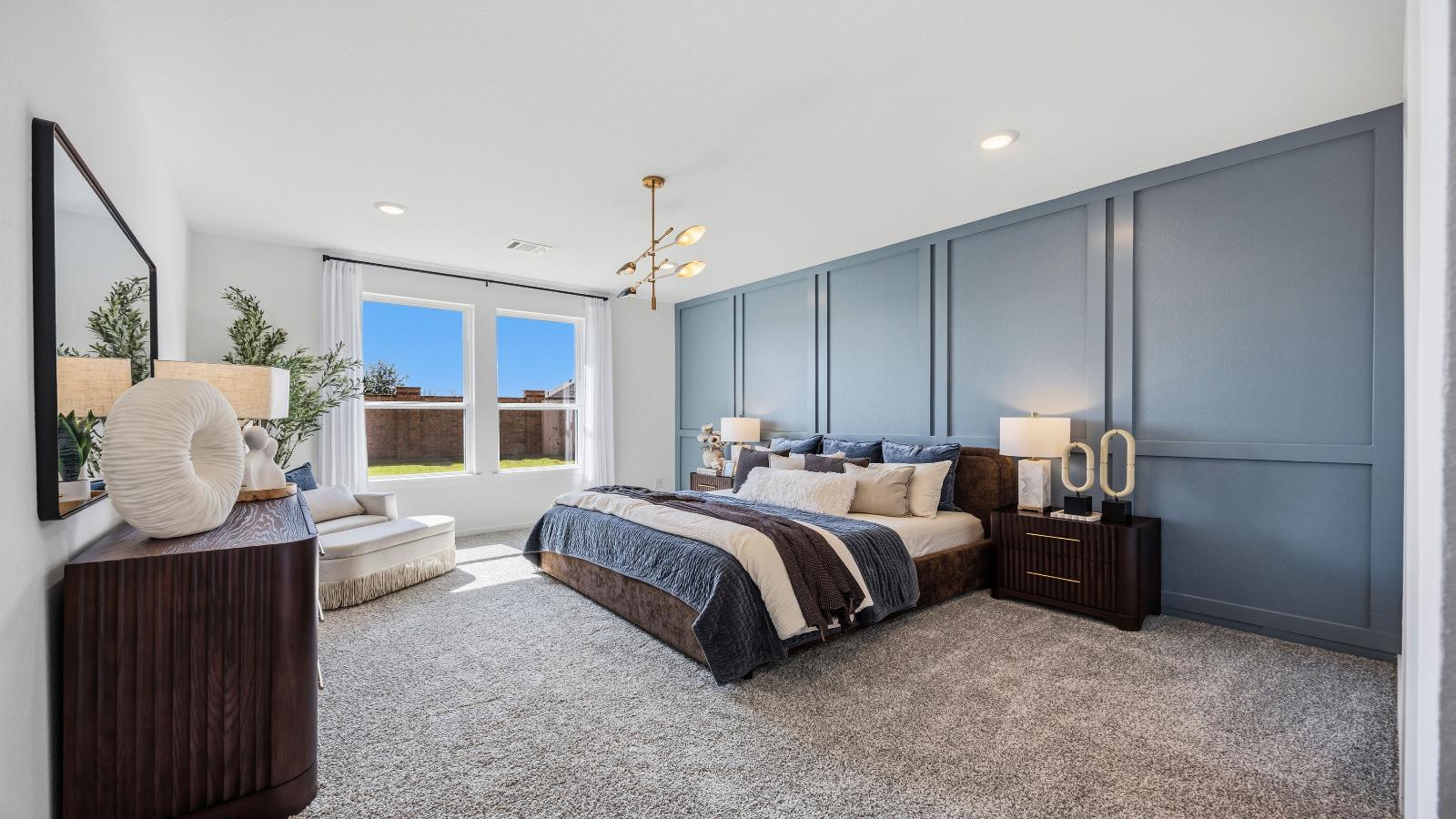 A spacious primary bedroom emphasizing open space and natural lighting with large windows.