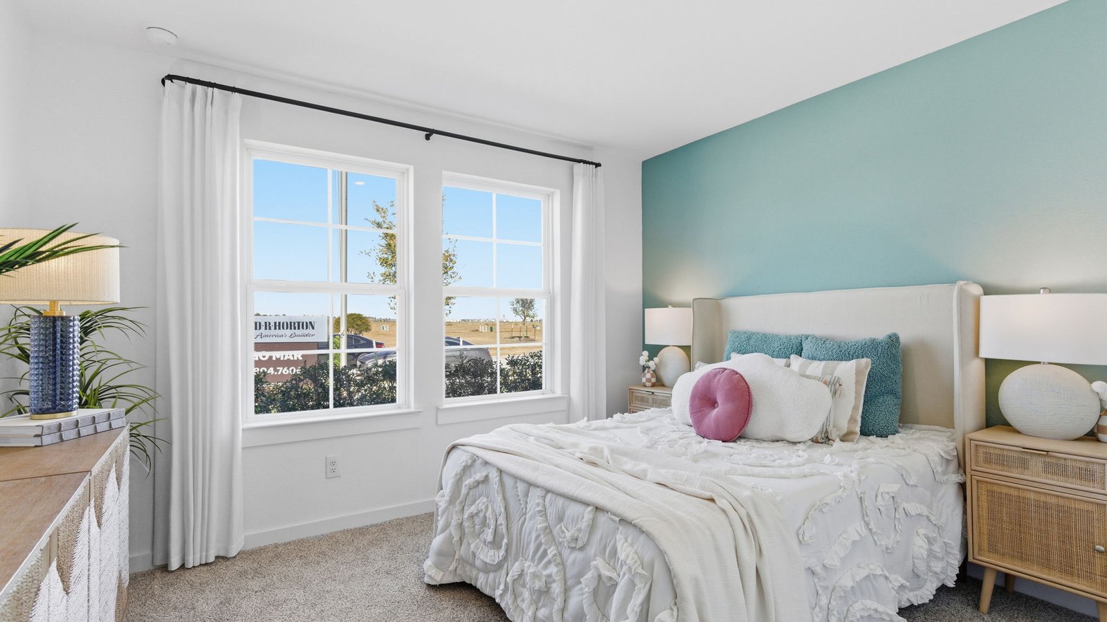 Comfortable guest bedroom featuring neutral-toned walls, carpeted flooring, and a separate closet.