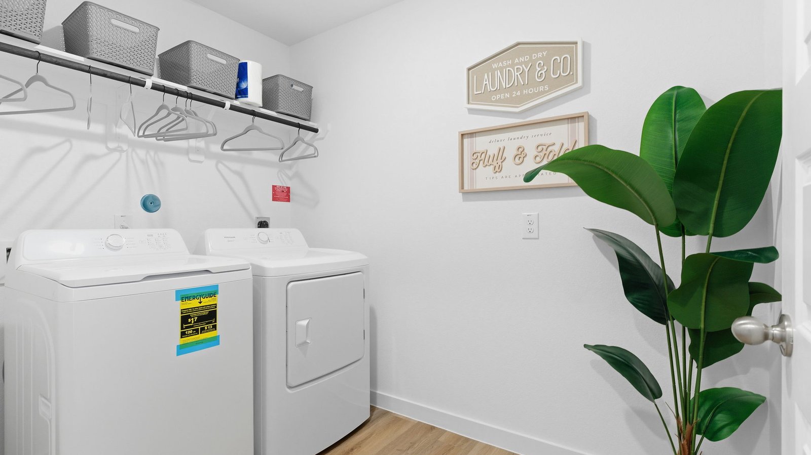 A laundry room featuring a washer and dryer, neatly arranged with ample space for laundry tasks and storage.