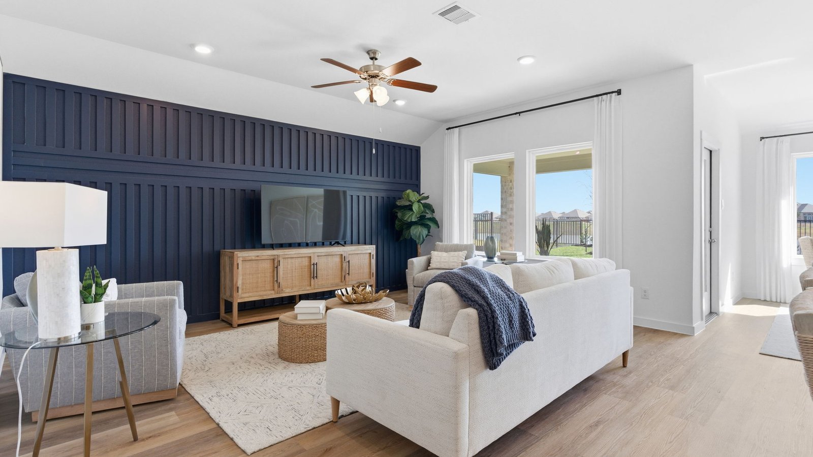 A well-organized living room that includes a kitchen and dining area, creating a warm and welcoming environment for gatherings.