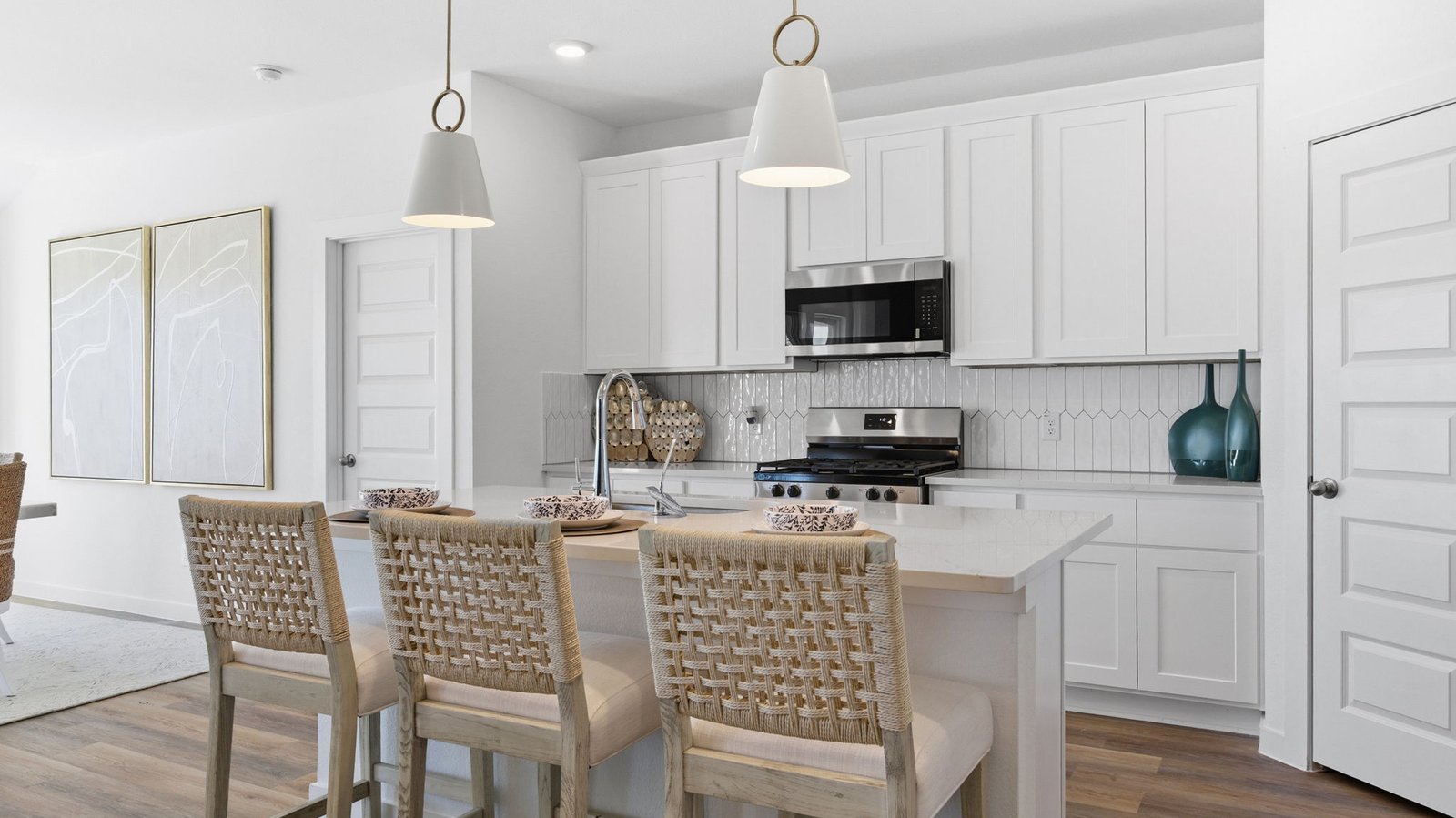 Bright and spacious kitchen with granite countertops, stainless steel appliances, and an island with bar seating.