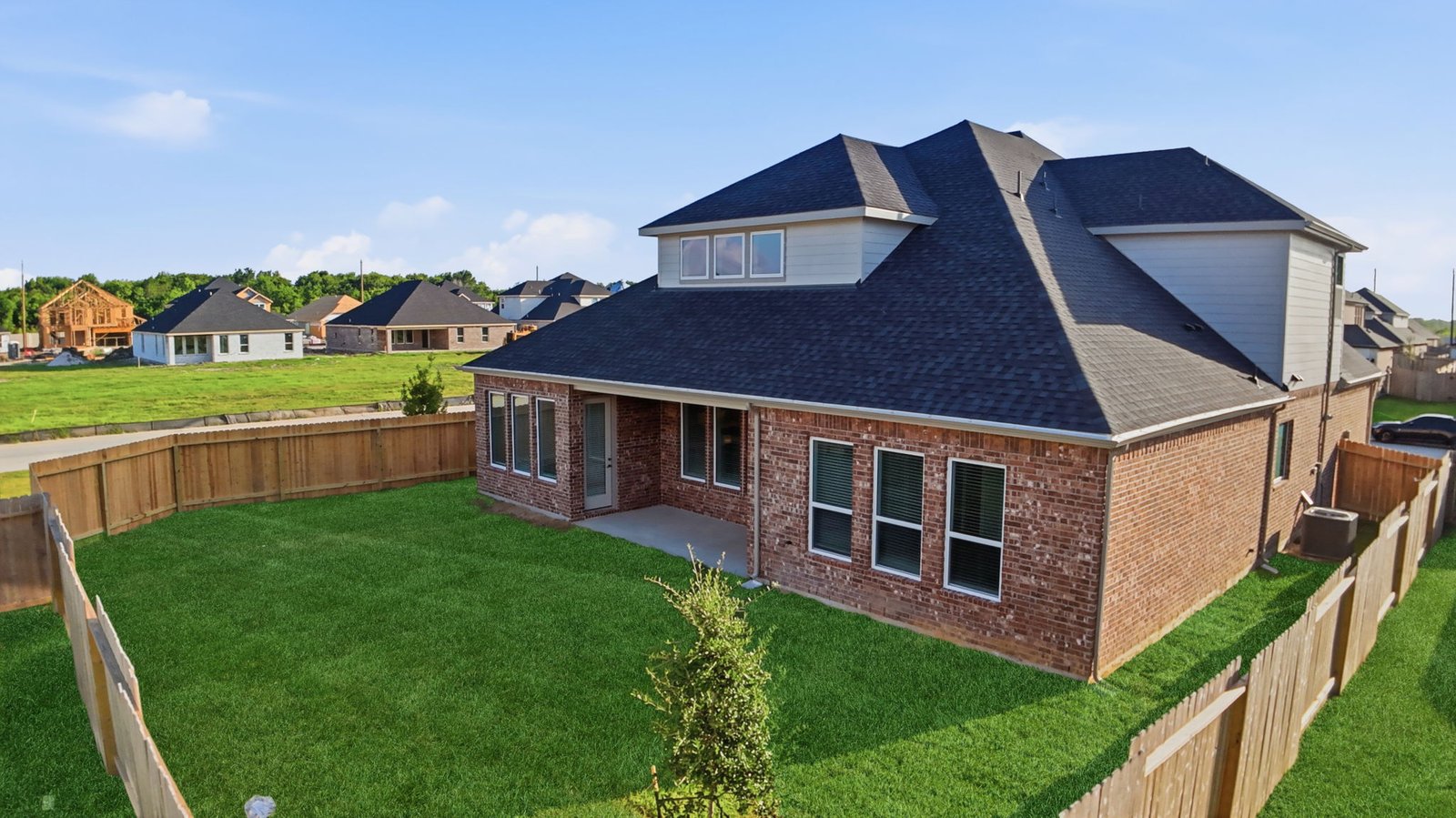 Large fenced-in backyard with a covered patio, perfect for outdoor entertaining.