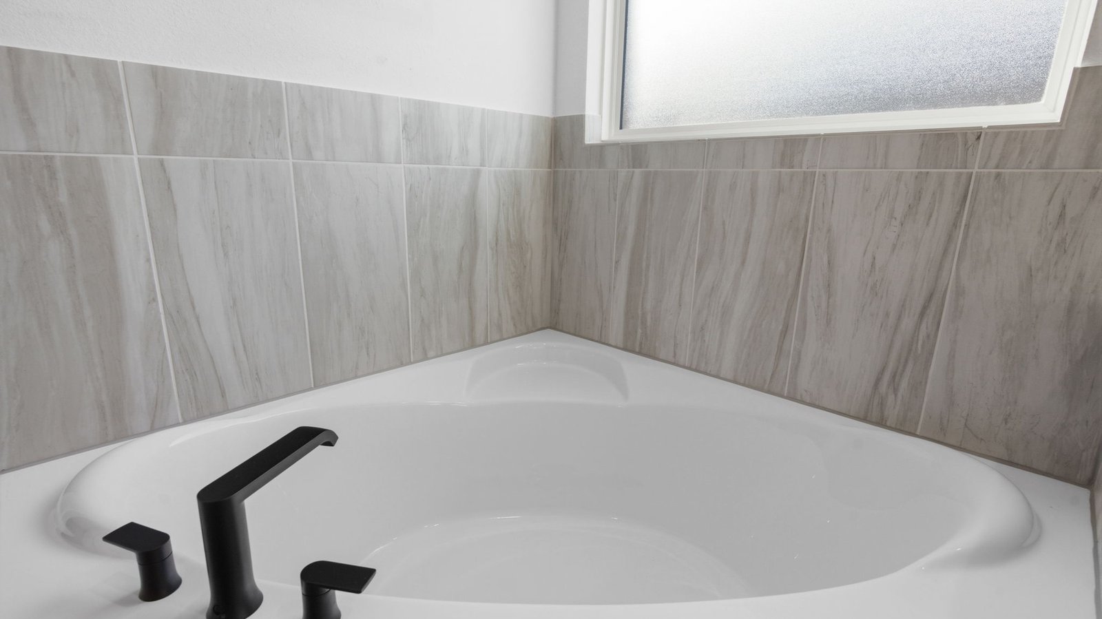 Primary bathroom with a glass-enclosed standing shower and separate soaking tub.