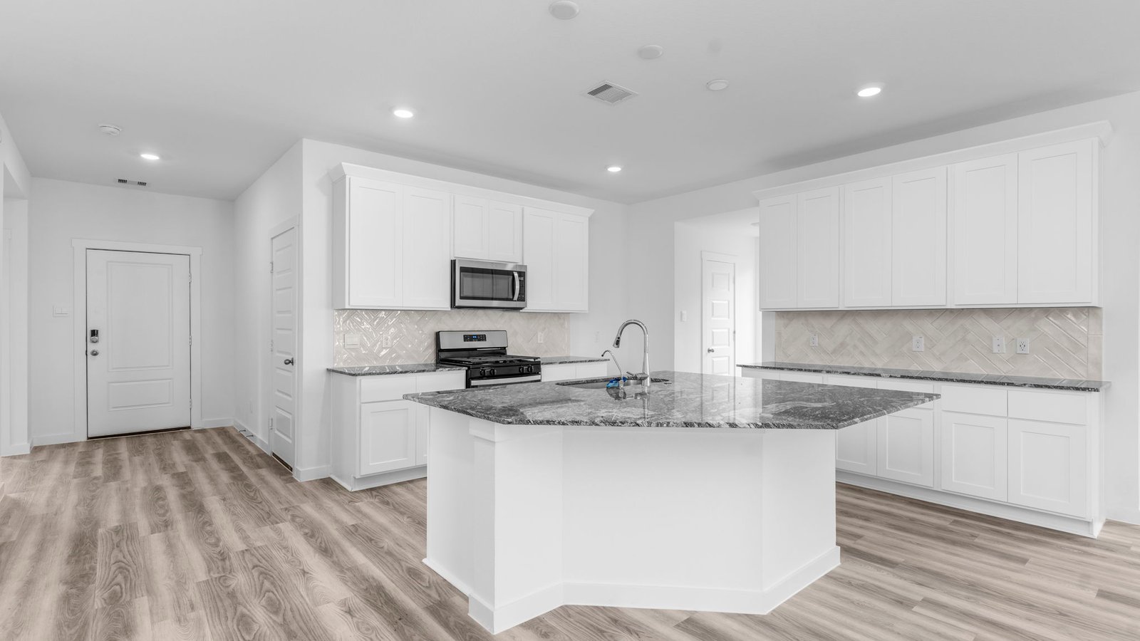 Kitchen adorned with painted cabinets seamlessly integrated into an open dining area layout.