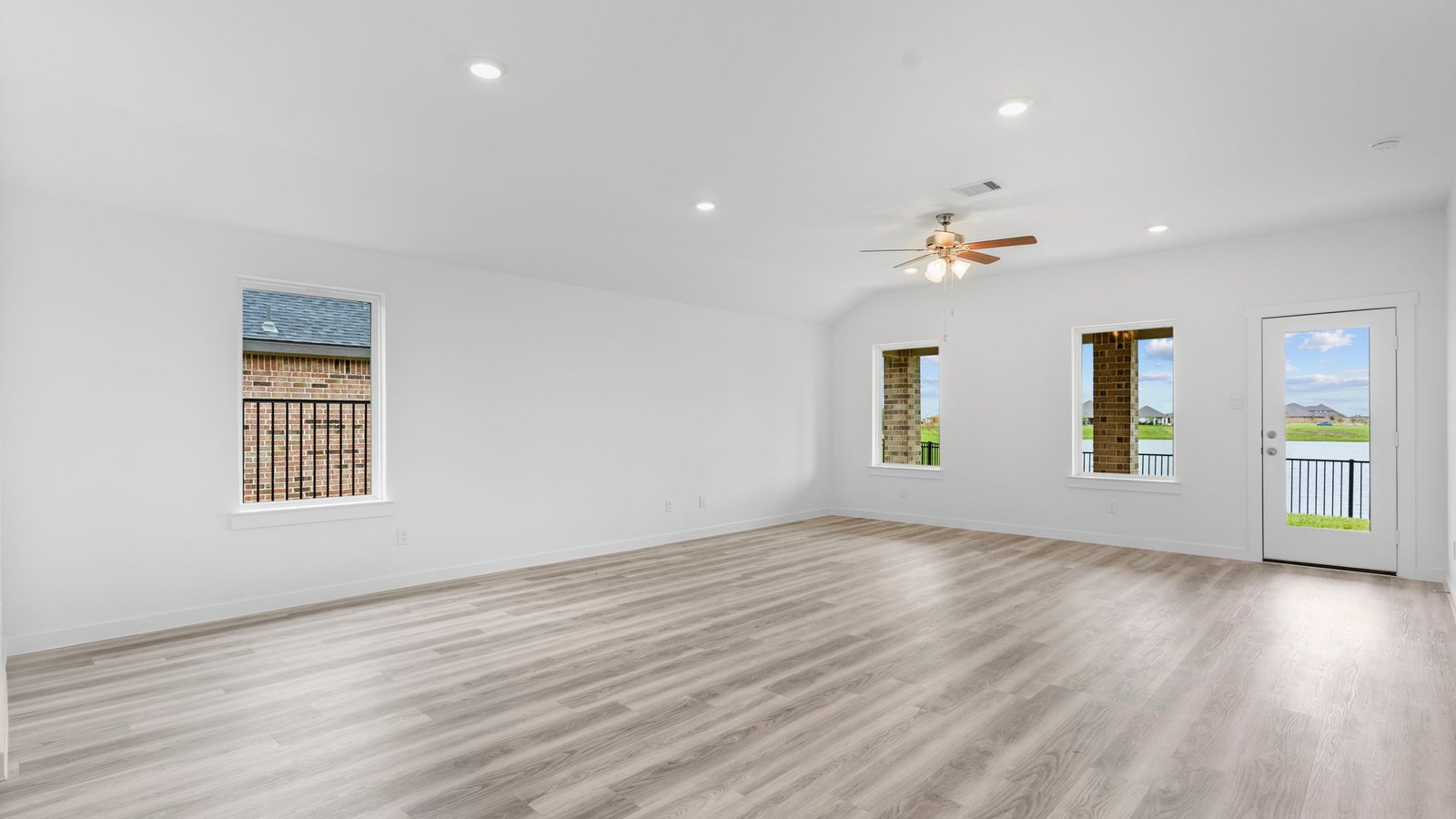 A well-organized living room that includes a kitchen and dining area, creating a warm and welcoming environment for gatherings.